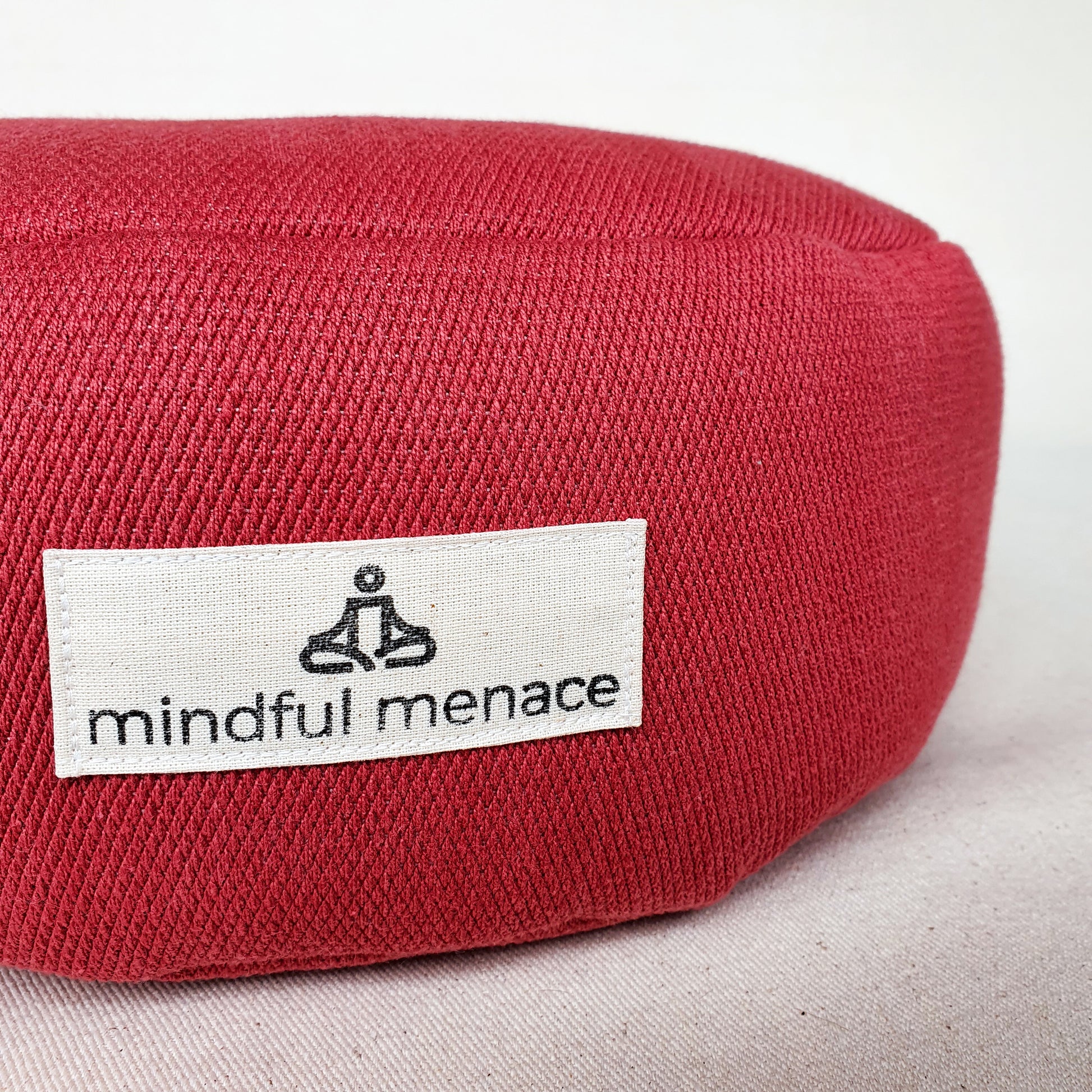 Mindful Menace logo on meditation cushion
